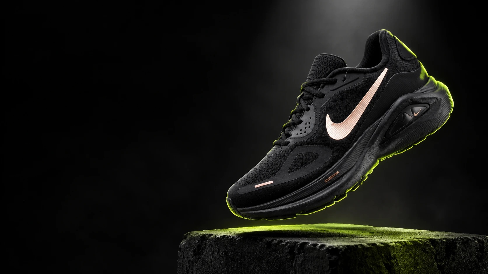 Nike Structure 26 negro con swoosh cobre sobre un bloque de concreto con luz verde